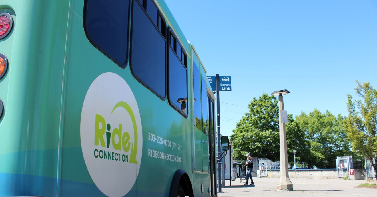 A close up of the Ride Connection on the side of a green and blue shuttle