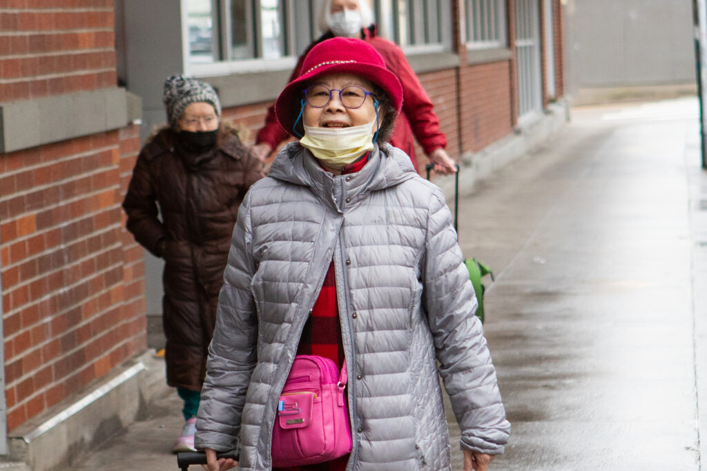 An older Asian woman walking on a Ride Connection shopping trip