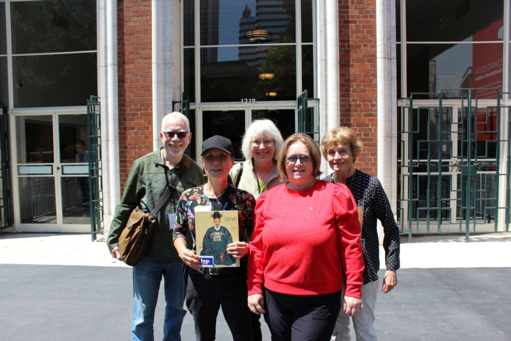 A group of five people stand together outside of the Portland Art Museum